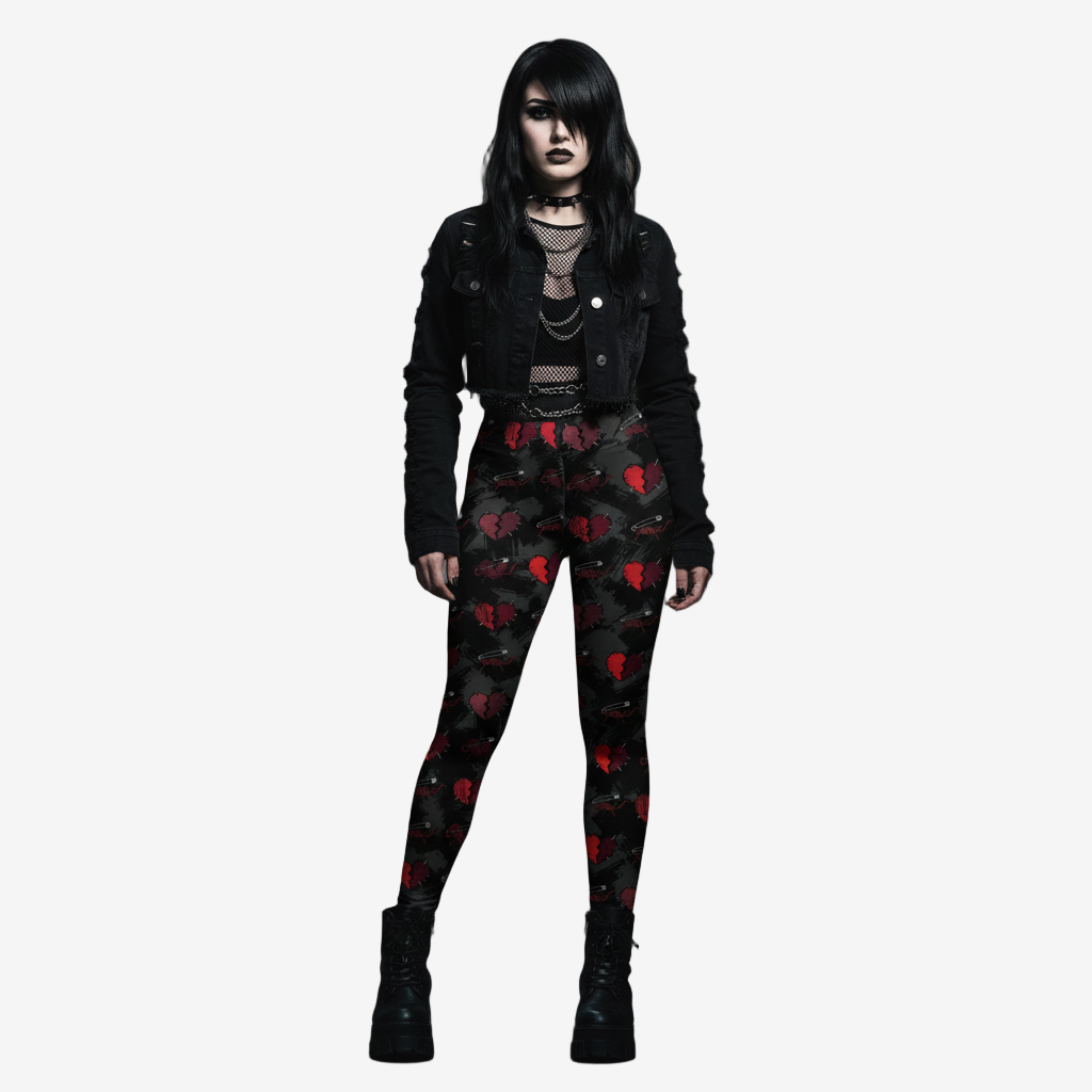 Woman in a dark alley wearing a black jacket and red patterned pants.